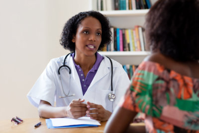  African american female doctor talking to patient