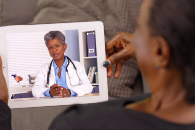 senior woman talking to a doctor on tablet