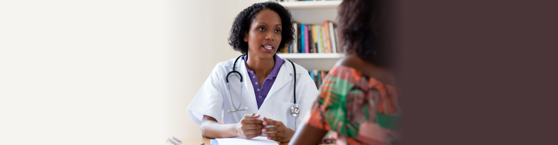African american female doctor talking to patient