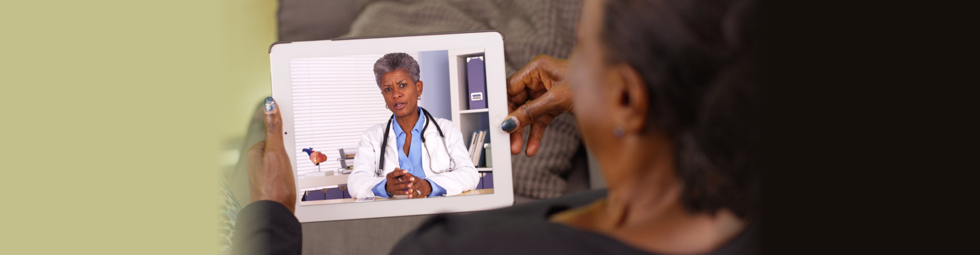 senior woman talking to a doctor on tablet