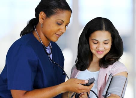 nurse checking blood pressure