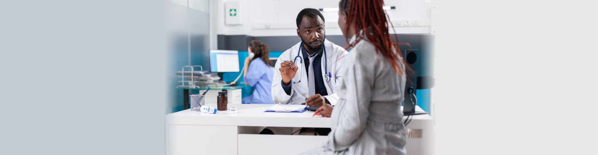 Patient with pregnancy discussing with general practitioner about healthcare and parenthood at consultation